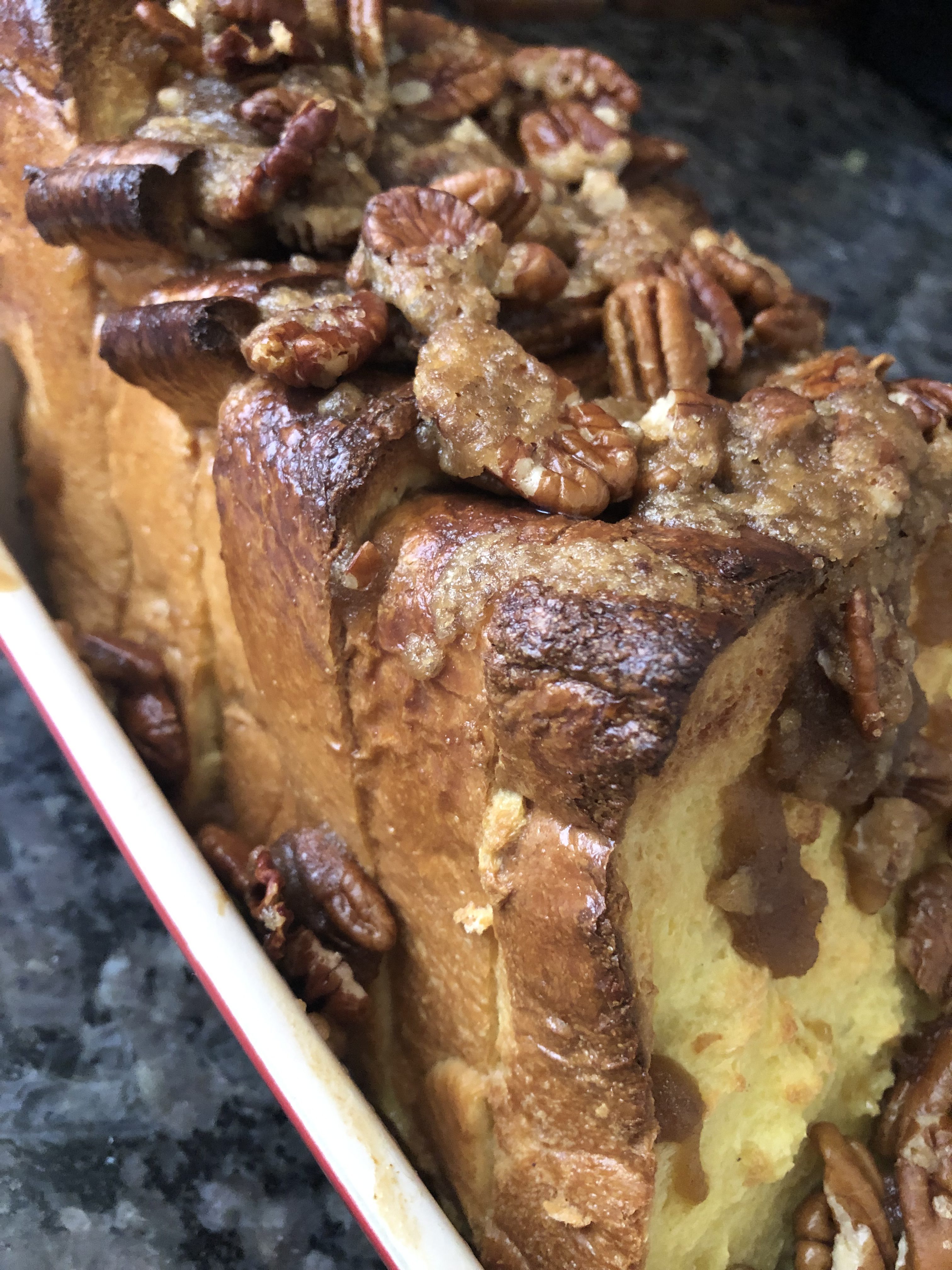 Egg Nog French Toast in a baking pan topped with candied walnuts