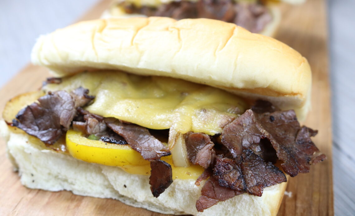 Hawaiian Sweet Mini Sub Rolls packed with Angus-beef, sauteed peppers and onions and melted American cheese