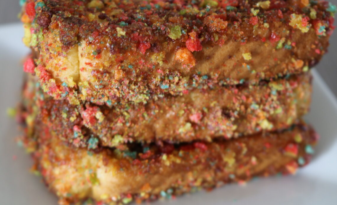 A stack of colorful Trix cereal coated Texas French Toast on a plate