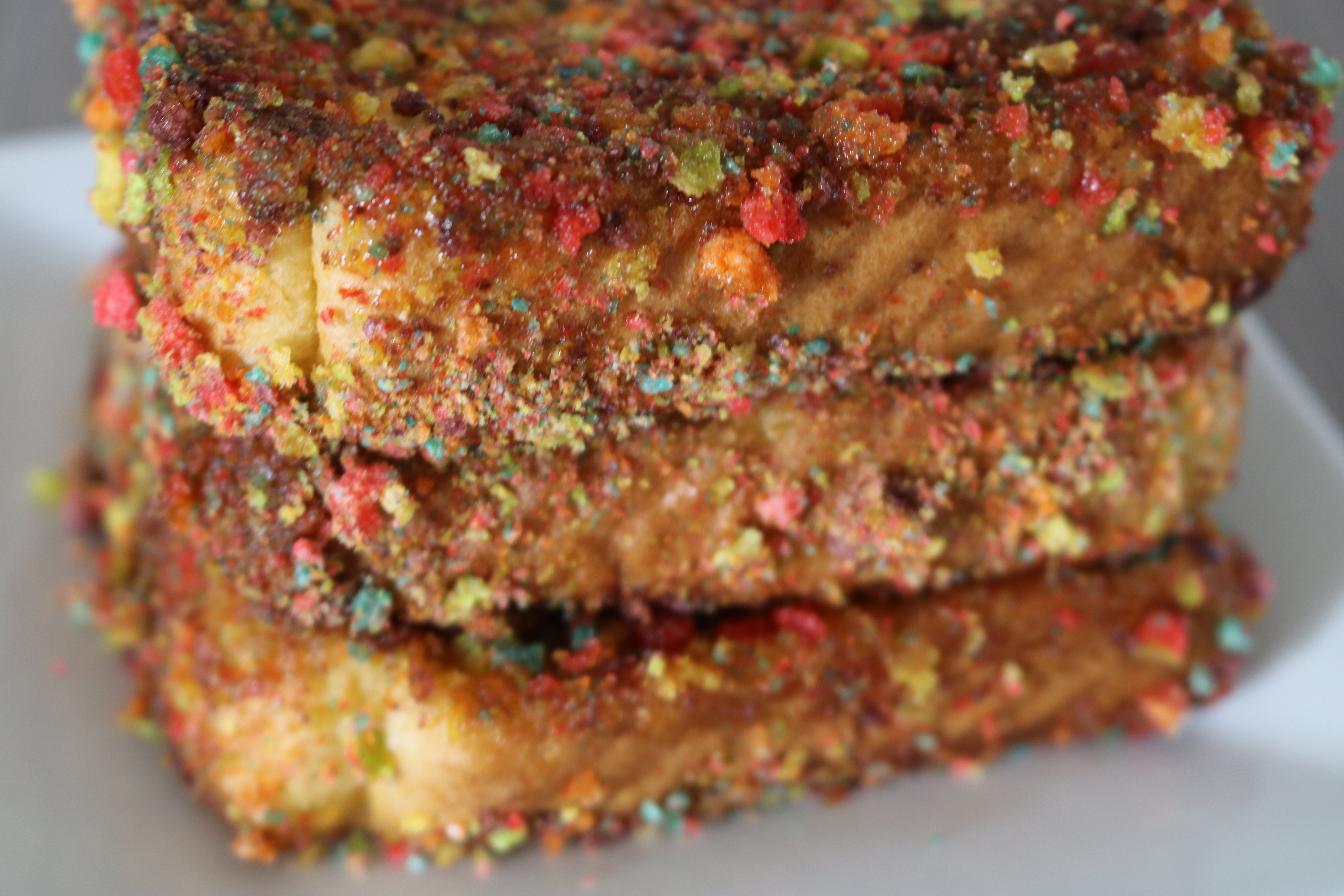 A stack of colorful Trix cereal coated Texas French Toast on a plate
