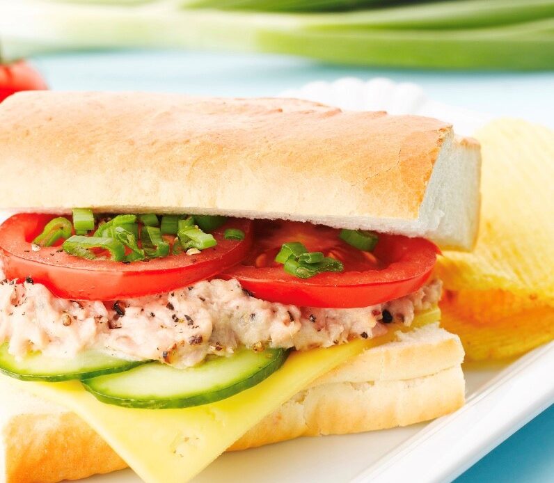 Tuna Salad on fresh Italian bread with cucumber slices, provolone cheese, tomato slices and chopped scallion