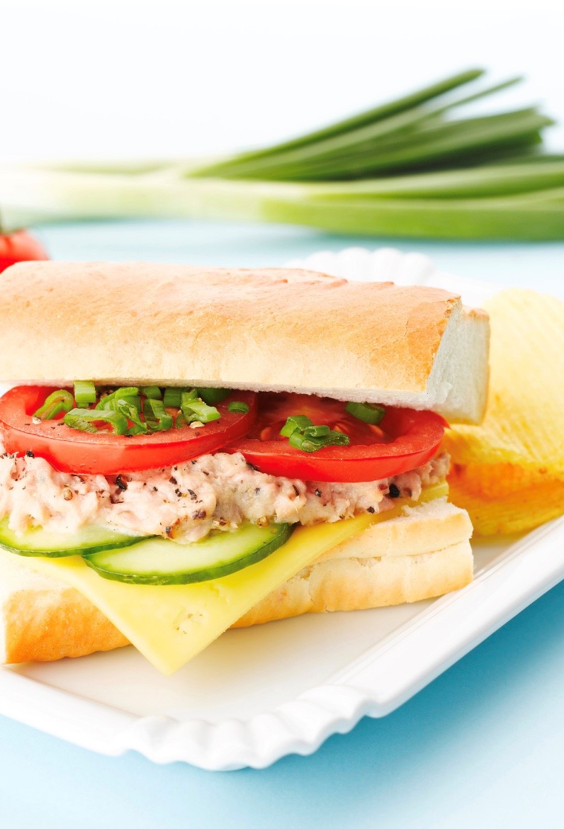 Tuna Salad on fresh Italian bread with cucumber slices, provolone cheese, tomato slices and chopped scallion