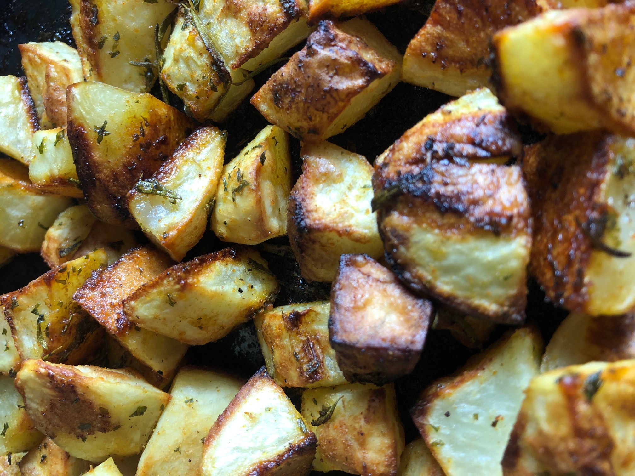 Oven roasted potatoes seasoned with olive oil, salt, pepper, cayenne, garlic powder, and rosemary.