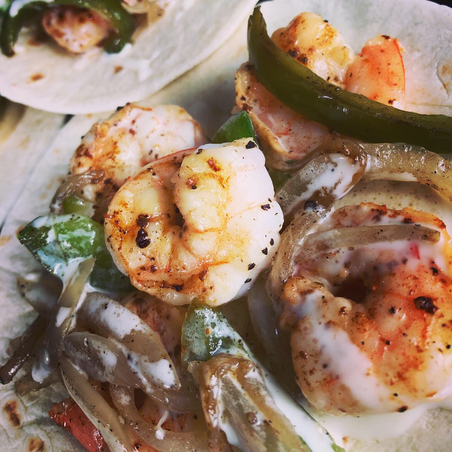 Flour tortilla toped with seasoned grill shrimp, sauteed pepper and onions, and creamy queso
