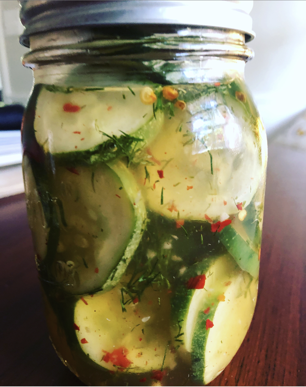 Homemade dill pickles in a Mason jar