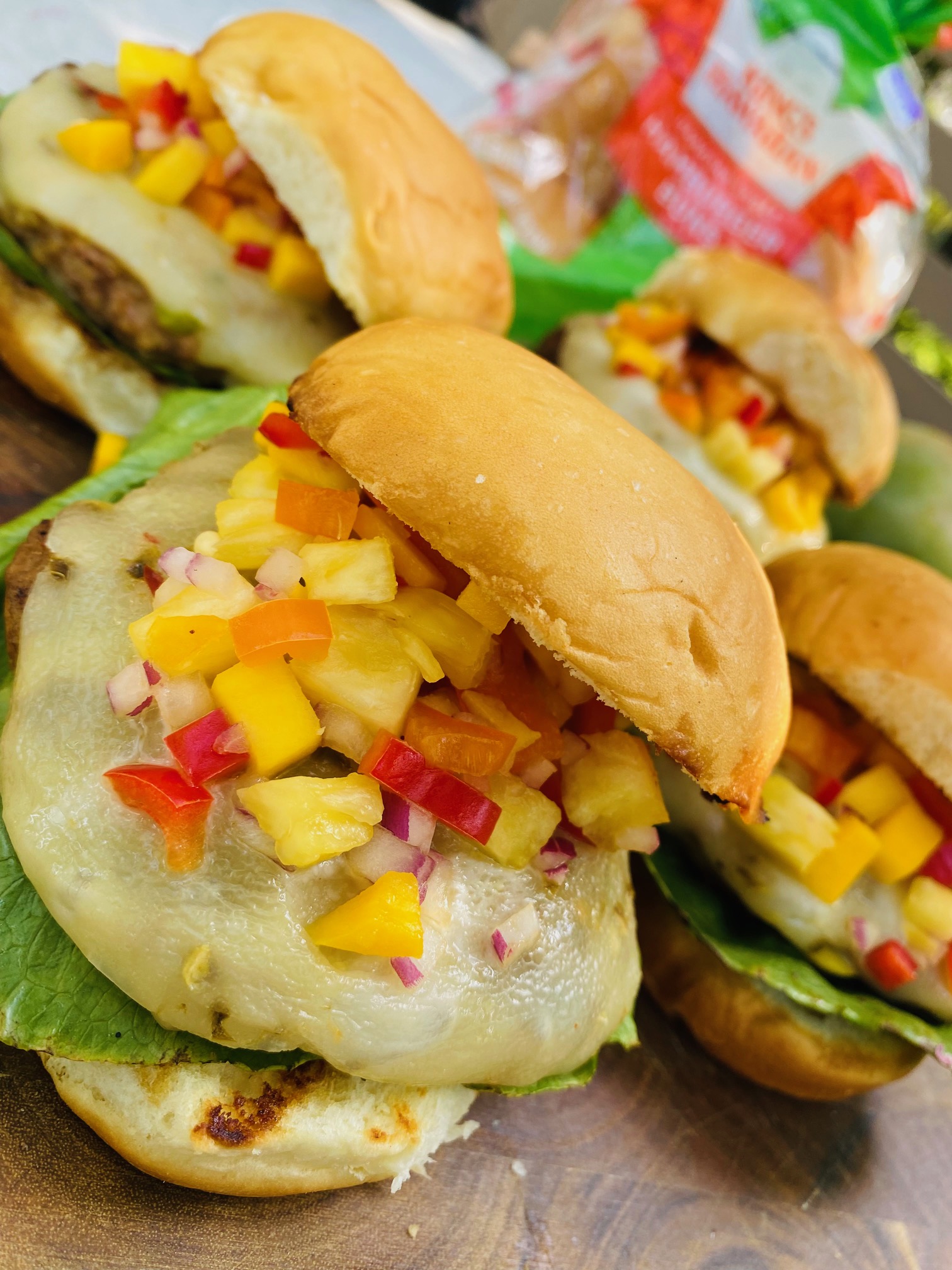 Grilled turkey burger patty covered and smothered in pepper jack cheese with a topped with mango pineapple salsa served on a KING'S HAWAIIAN Sweet Hamburger Bun.